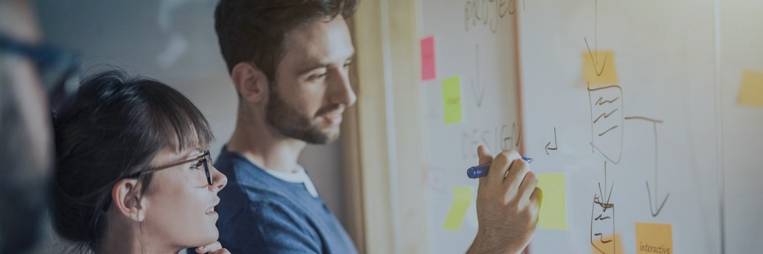 People in a meeting writing on a chart