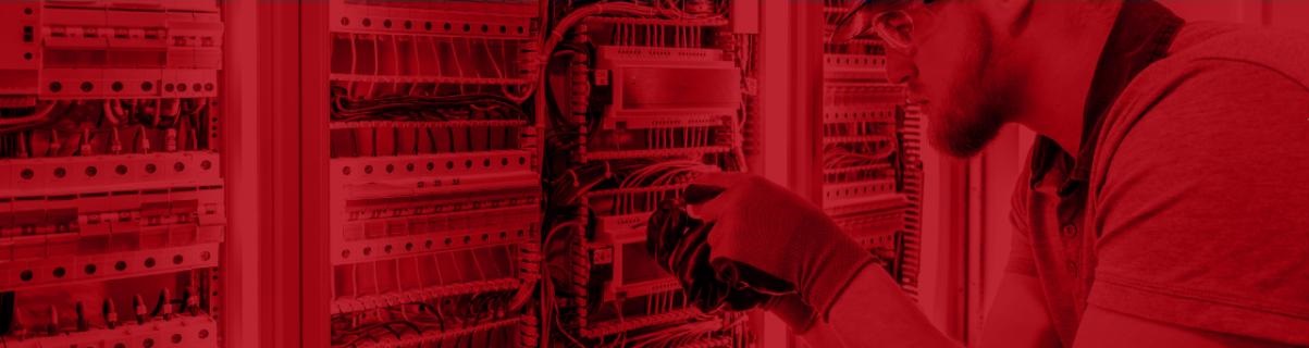 Technician installing OT sensors on a board (screened image in red)