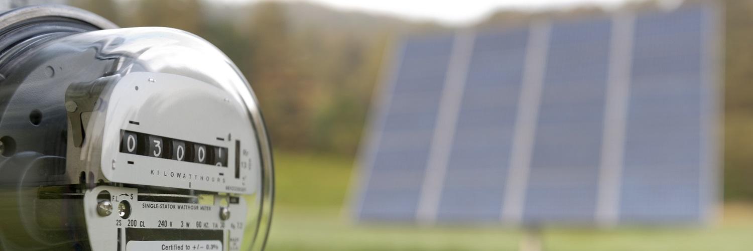 close up of meter with solar panel in the background