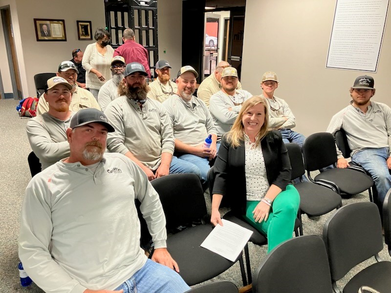 Jennifer Freeman (center) with lineworkers from Griffin Power.