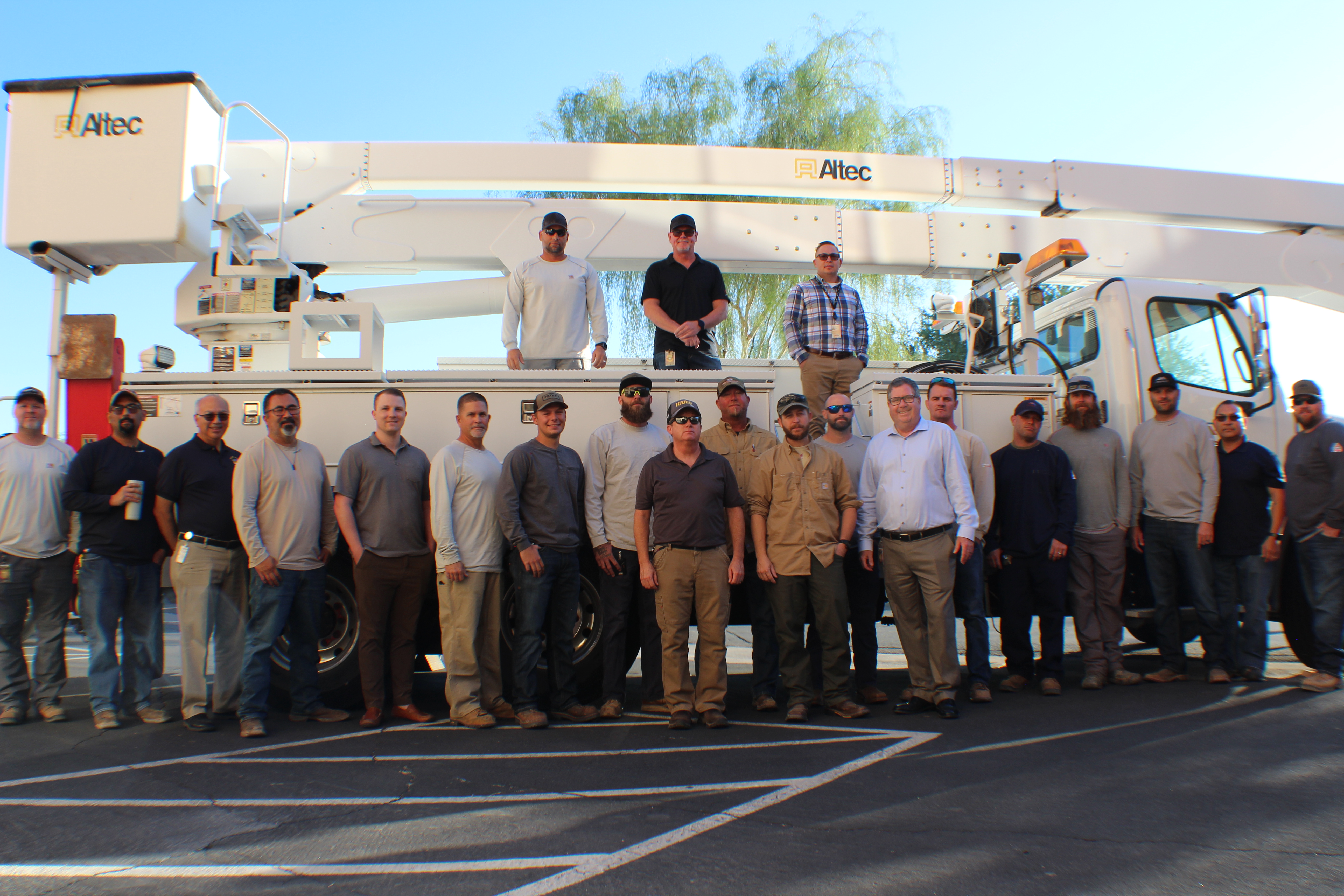 Mesa Electric staff photo in front of a bucket truck.