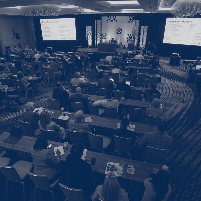 Attendees listening during conference session