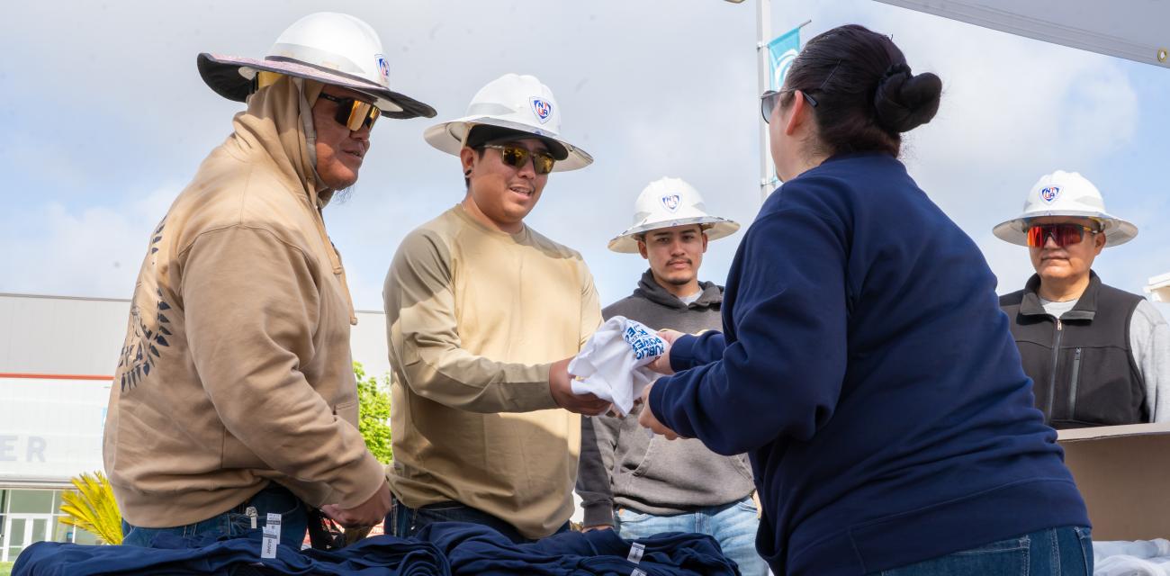 Lineworkers receiving their competition t-shirts