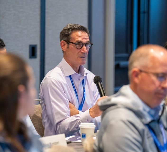 Person talking into microphone during conference session