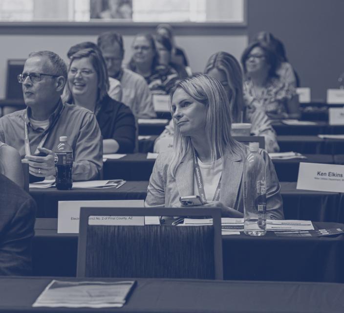 Attendees listen during a conference session