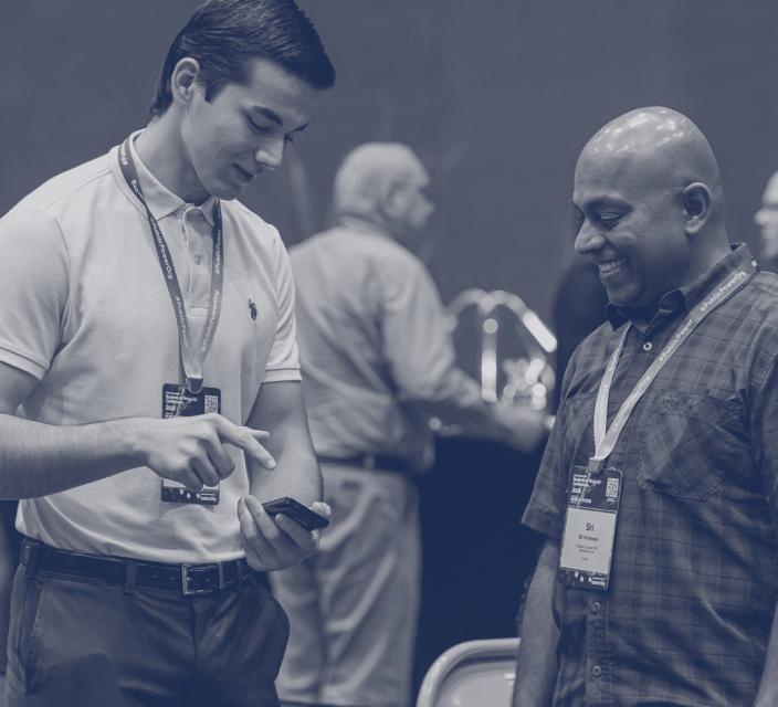 Two people smiling and looking at a phone