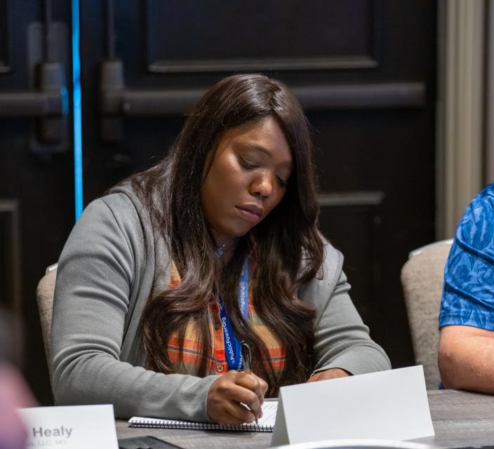 Person taking notes during conference session