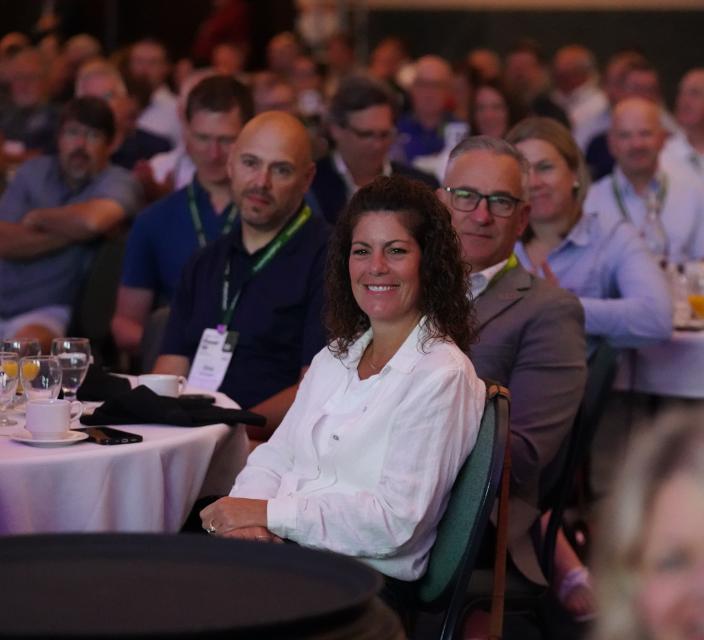 Person smiling during conference session