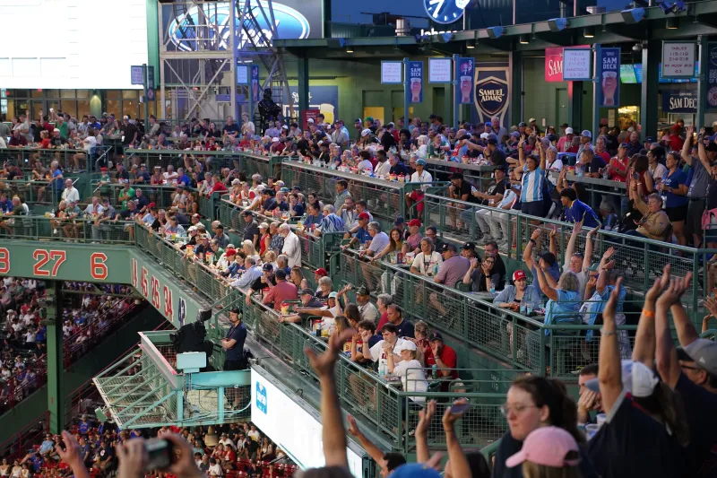 Fans cheering at Fenway Park