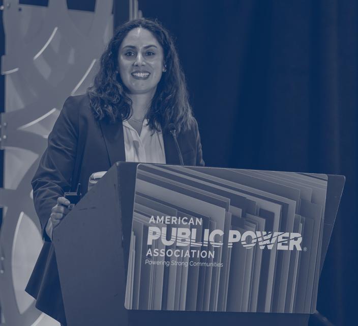 Person speaking at podium during Legal & Regulatory Conference
