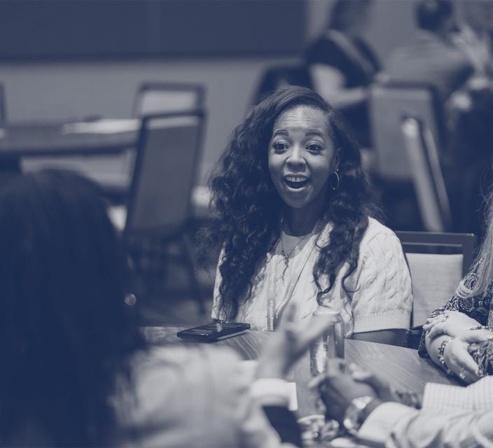 People talking and laughing during conference session