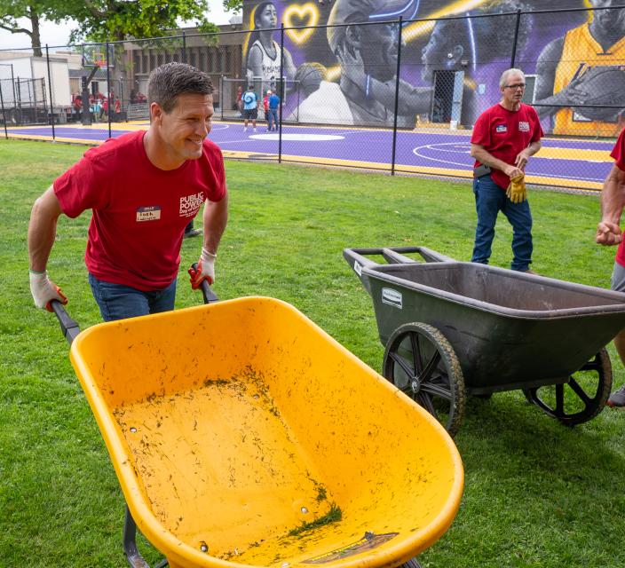 Person pushing wheelbarrow