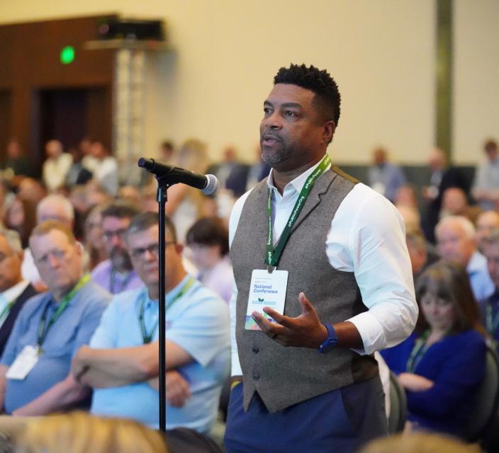 Person speaking at microphone
