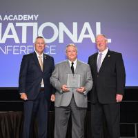 David Osburn, Thomas Heller, and Tony Cannon pose as Heller receives his award.