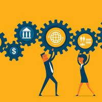 People holding a line of interconnected cogs