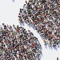 birds eye view of crowd of people standing in the shape of conversation bubbles