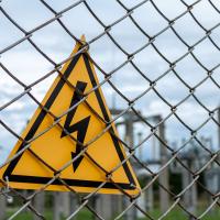 electric warning sign on substation fence