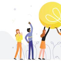 Five people holding up a large light bulb