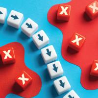 small blocks with arrows making a curved pathway around small blocks with exes