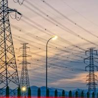 Electric transmission towers and lines at sunset