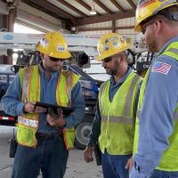 Three workers in a safety briefing
