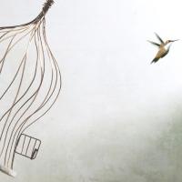 bird flying out of a birdcage