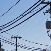 utility poles and lines against a blue sky