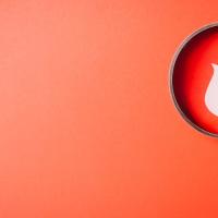 Graphic of a magnifying glass over a flame graphic against a red background