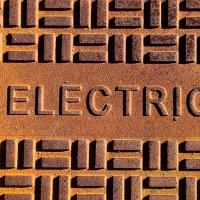 A close-up photo of a manhole cover labeled "ELECTRIC."