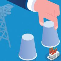 hand lifting up a cup with a transformer underneath