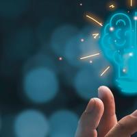 light bul and brain icon floating above a hand