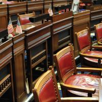 detail of seats in a legislative chamber with US flags