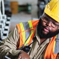 two utility workers inspect wiring