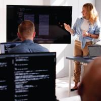 woman leading a training in front of computers