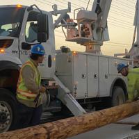 Austin Energy lineworkers setting up a new electrical pole