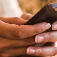 hands holding phone texting