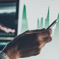 person pointing at a chart