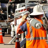 electric utility trucks and workers