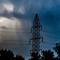 lightning behind a transmission tower