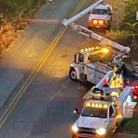 Bucket trucks on a storm response effort at night