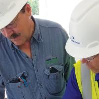 Idaho Falls Power employees looking at a schematic