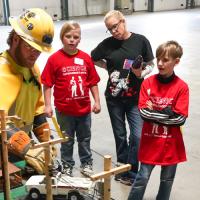 Lincoln Electric System employees doing a demonstration at a school science fair
