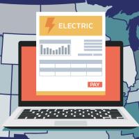 Map of the continential united states with a computer and electric bill over it