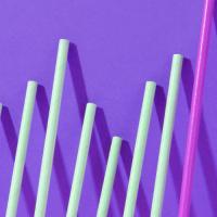 series of round rods leaning against a purple wall