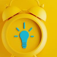 yellow alarm clock on yellow background