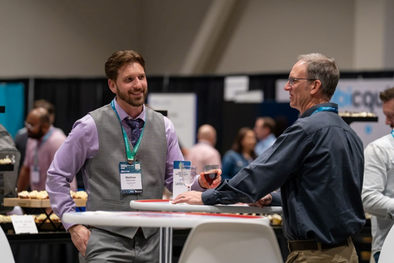 Two men talking at a high top table at the APPA Engineering and Operations Conference