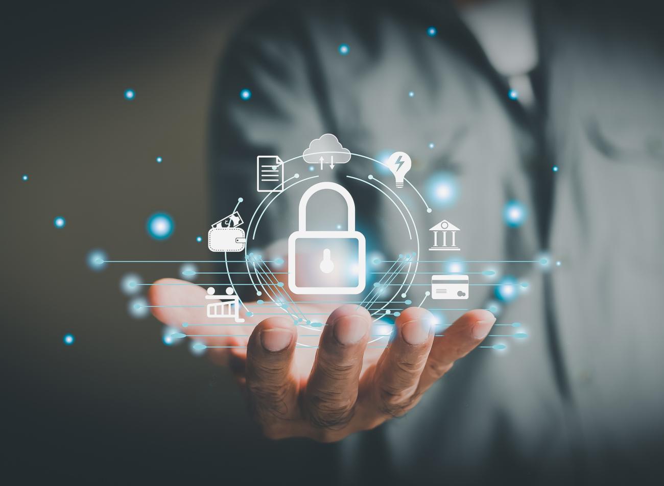 Series of computer related icons floating above a person's hand