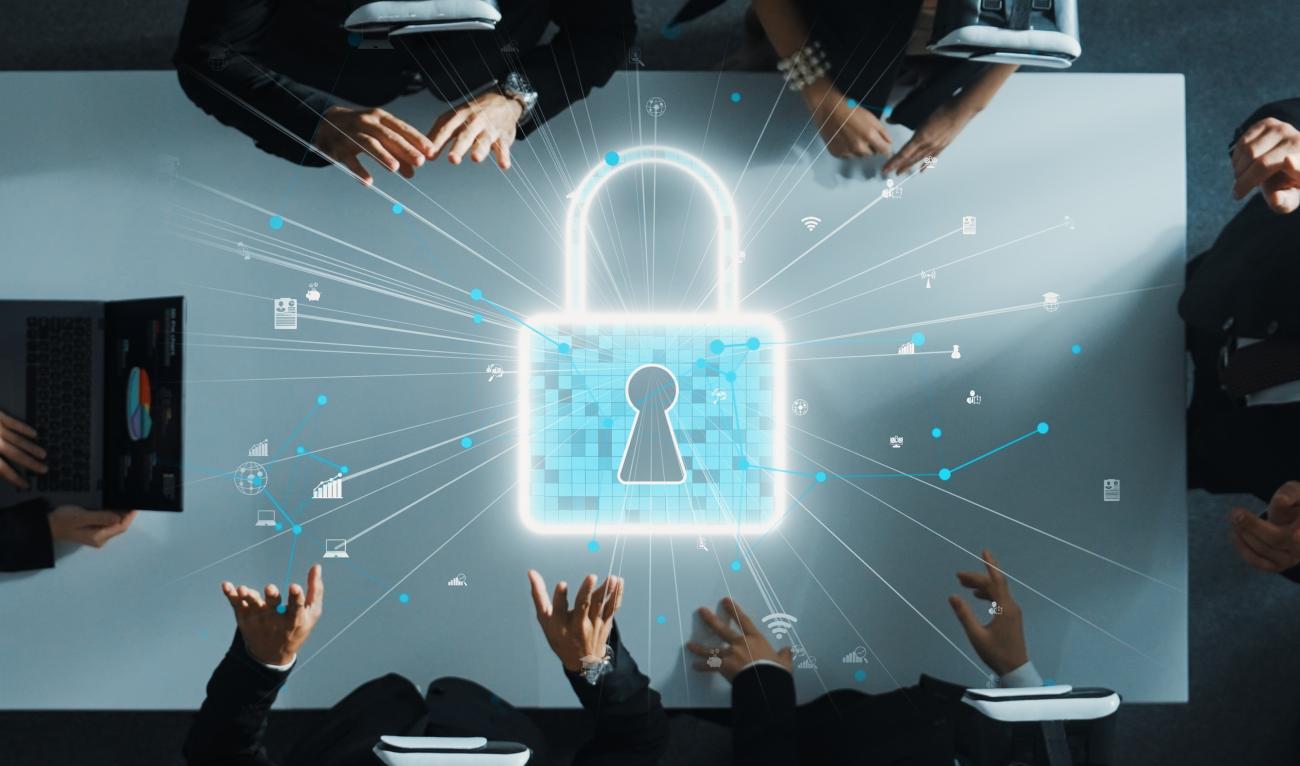 A lighted padlock image emanating a radial pattern on a meeting table surrounded by six people