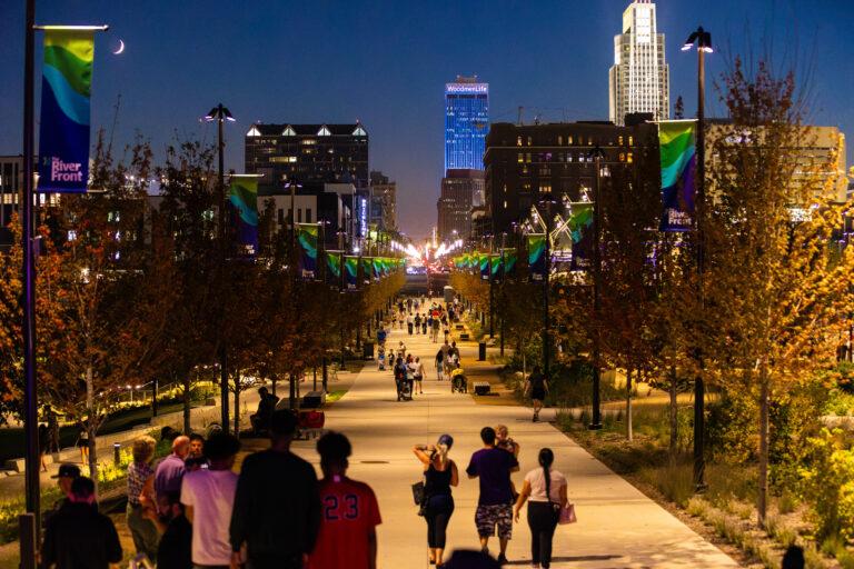 People walking Omaha's river front at night