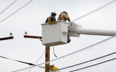 Crew in a bucket truck works to restore frozen lines